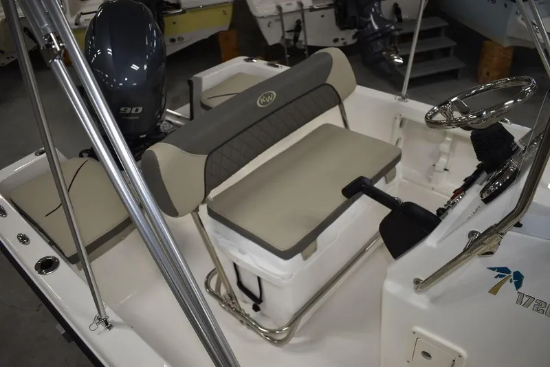 Slide: The Image of 2025 Key West 1720 CC boat interior with seating and steering wheel. - 17