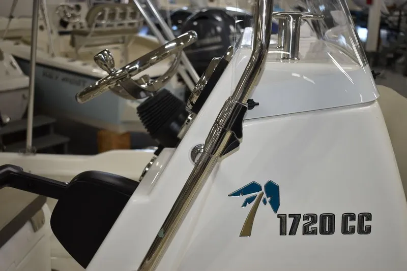 Slide: The Image of 2025 Key West 1720 CC boat interior with steering wheel and console. - 19