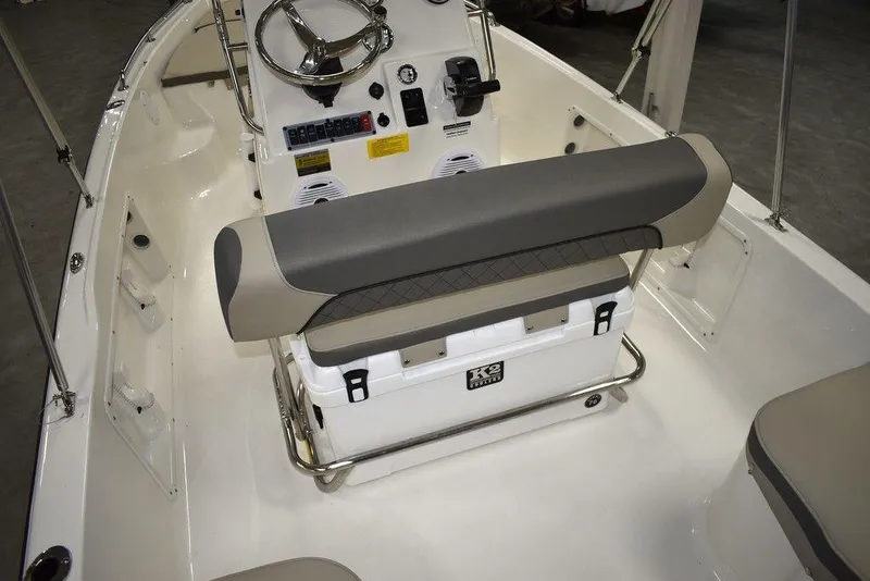 Slide: The Image of 2025 Key West 1720 CC boat interior with steering console and cushioned seating. - 22