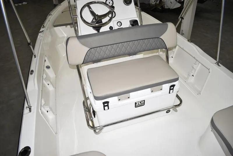 Slide: The Image of 2025 Key West 1720 CC boat interior with steering console and cushioned seating. - 23