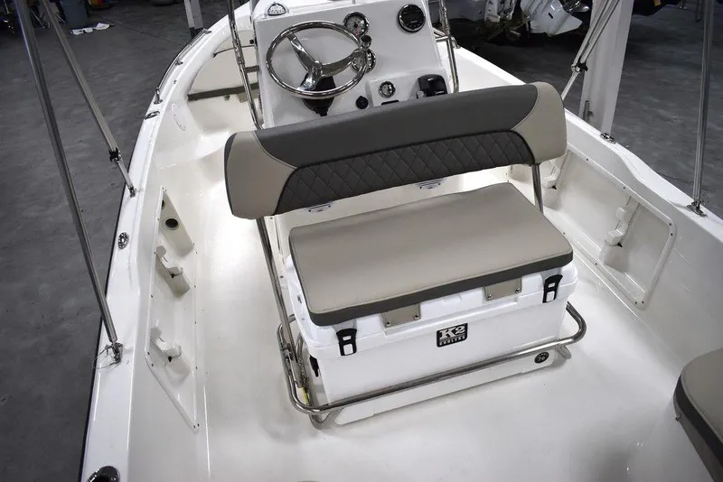 Slide: The Image of 2025 Key West 1720 CC boat interior with steering console and cushioned seating. - 24