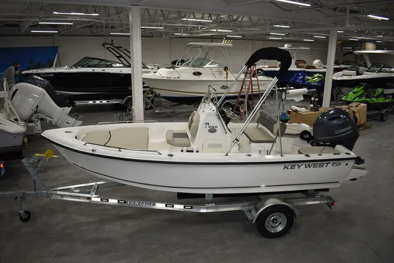 Slide: The Image of 2025 Key West 1720 CC boat in showroom, on trailer, with Yamaha outboard motor. - 3