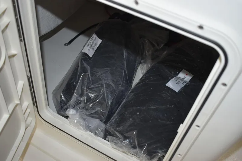 Slide: The Image of Storage compartment in 2025 Key West 1720 CC boat with packaged items. - 36