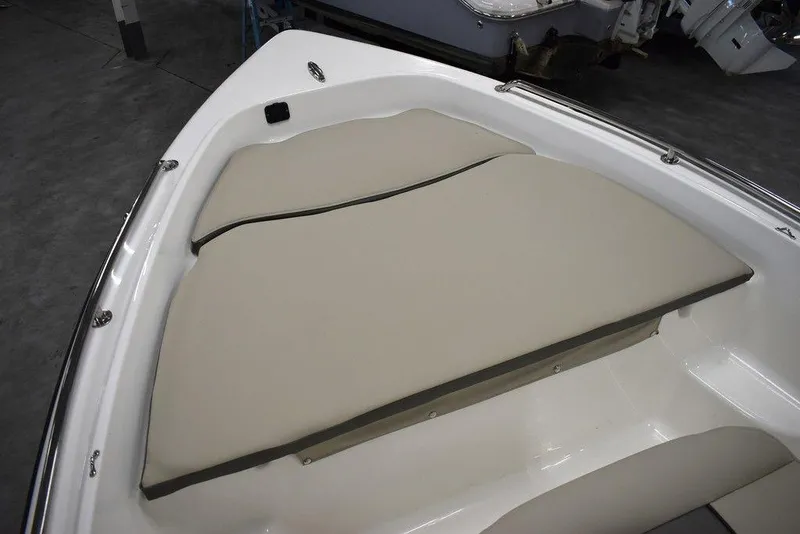Slide: The Image of 2025 Key West 1720 CC boat with beige cushioned seating in the bow area. - 38