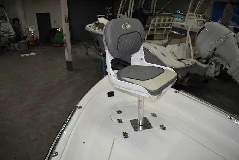 Slide: The Image of 2025 Key West 1720 CC boat with a swivel seat in a showroom. - 44