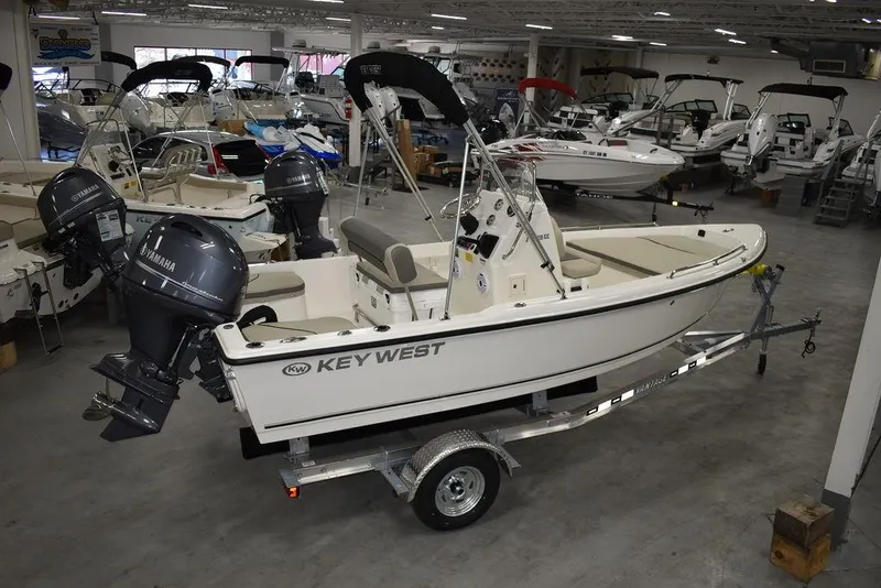 Slide: The Image of 2025 Key West 1720 CC boat on trailer in showroom with Yamaha outboard motor. - 7