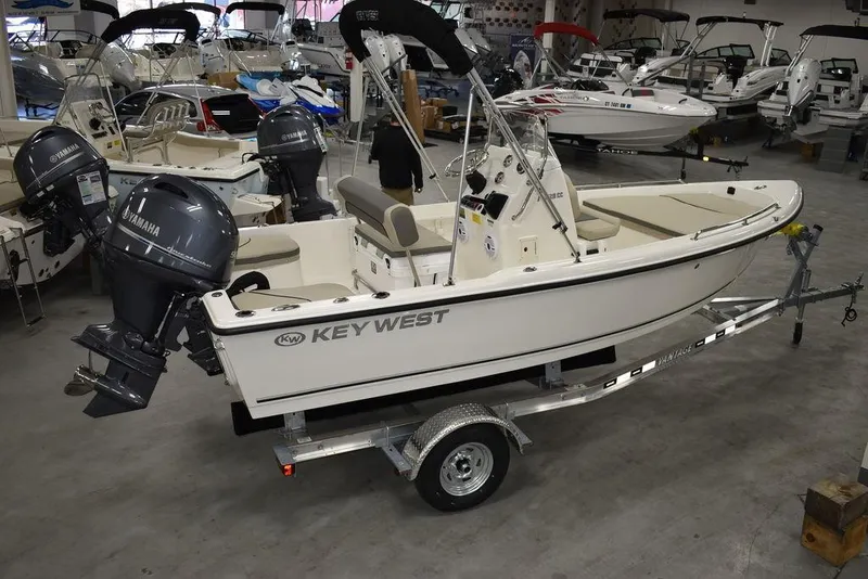 Slide: The Image of 2025 Key West 1720 CC boat on trailer in showroom with Yamaha outboard motor. - 8