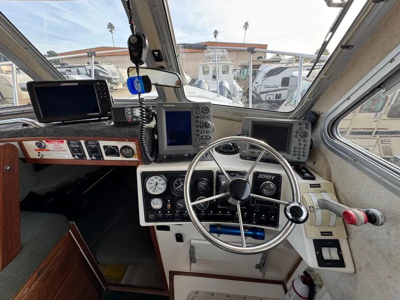Slide: The Image of Interior cockpit of 1999 Osprey 26 Legend boat with navigation equipment and steering wheel. - 10