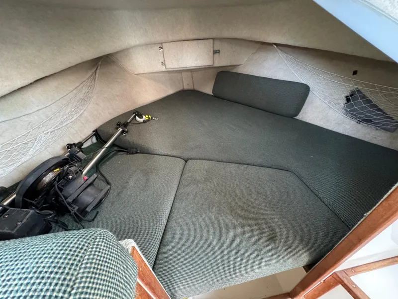 Slide: The Image of Interior cabin of 1999 Osprey 26 Legend boat with cushioned sleeping area. - 11
