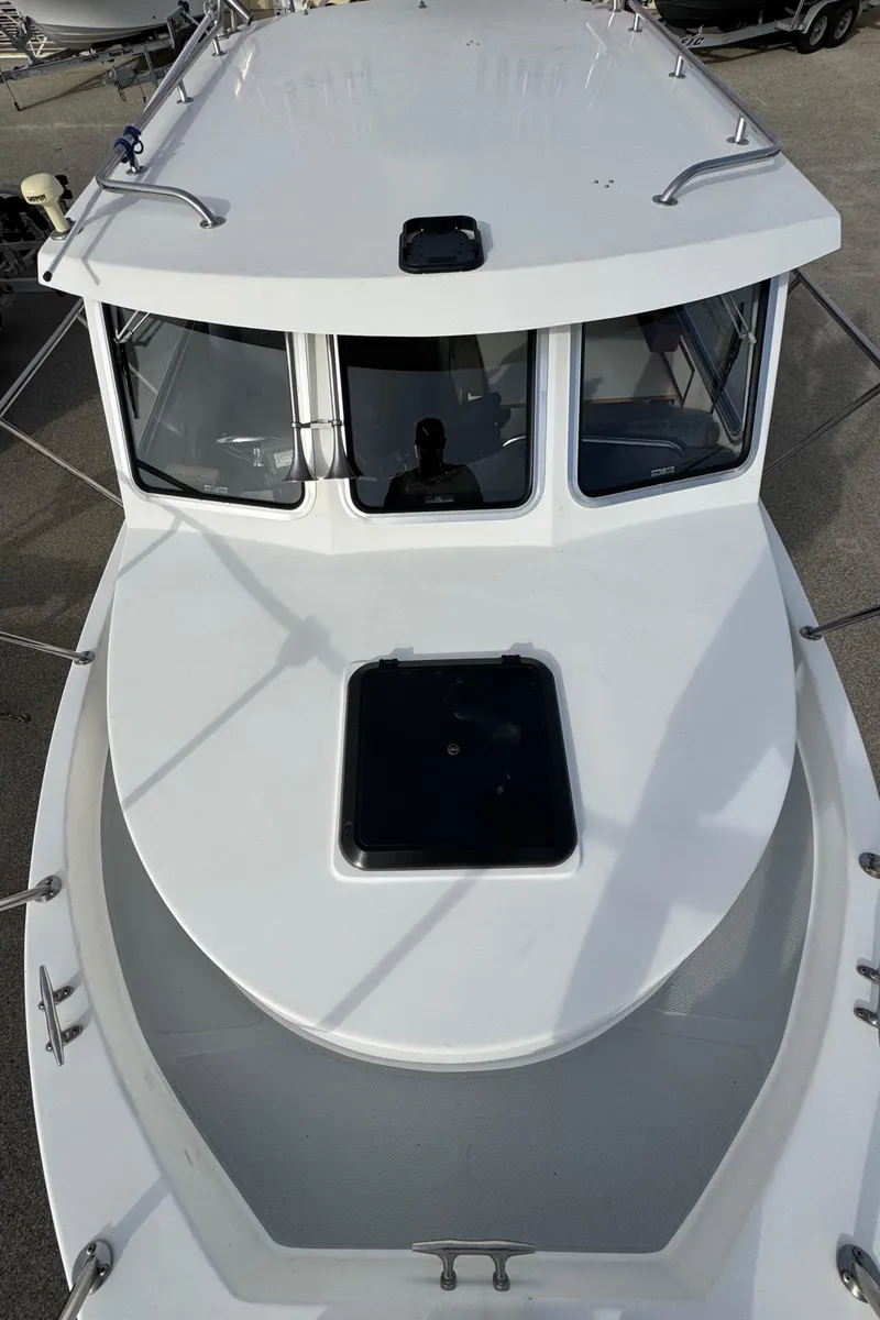Slide: The Image of 1999 Osprey 26 Legend boat, white exterior, top view of cabin and deck. - 13