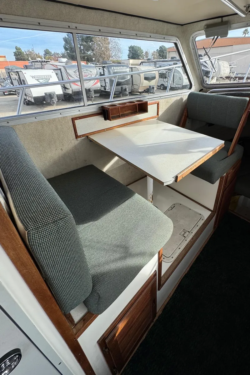 Slide: The Image of Interior of 1999 Osprey 26 Legend boat with seating and table. - 14