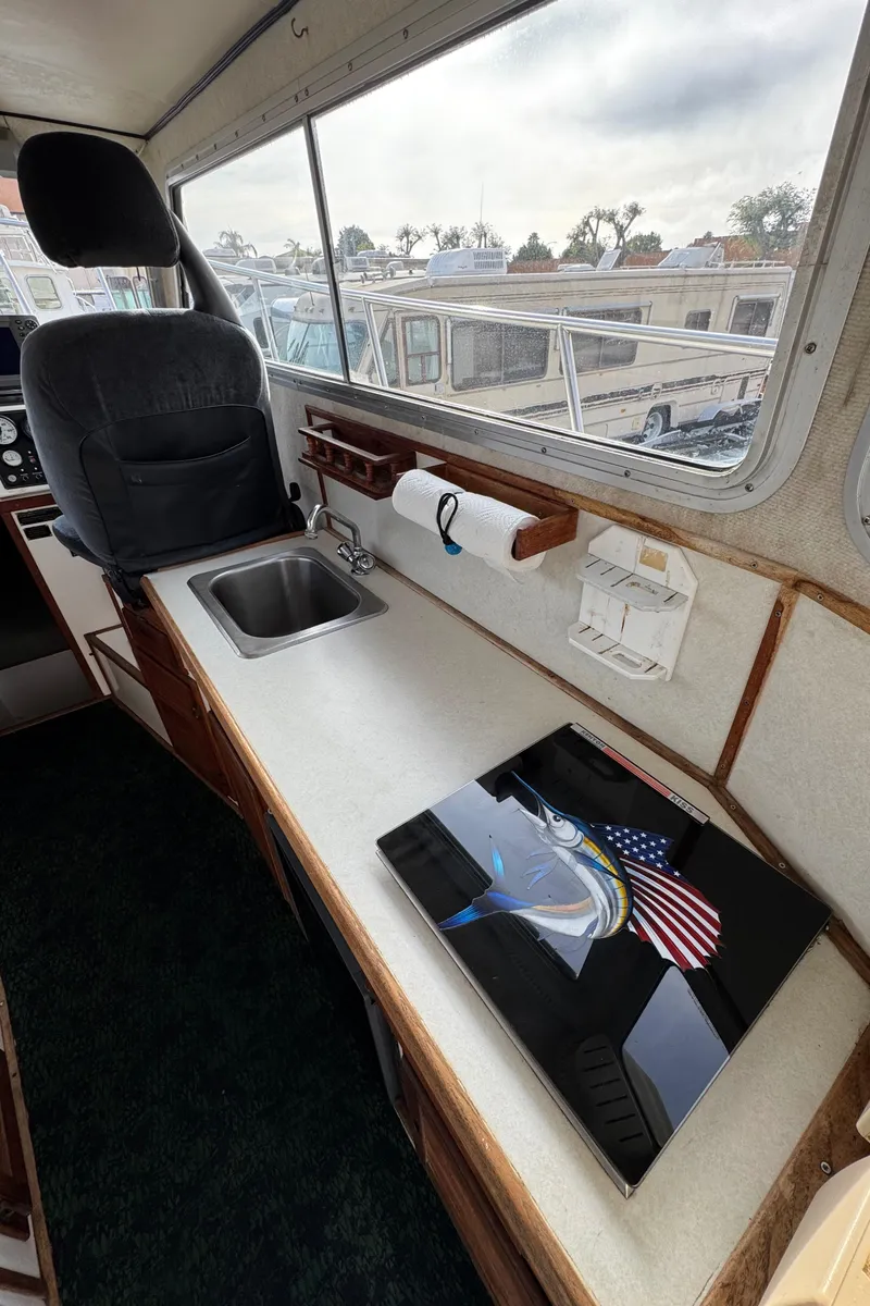 Slide: The Image of Interior of 1999 Osprey 26 Legend boat with sink and counter space. - 15