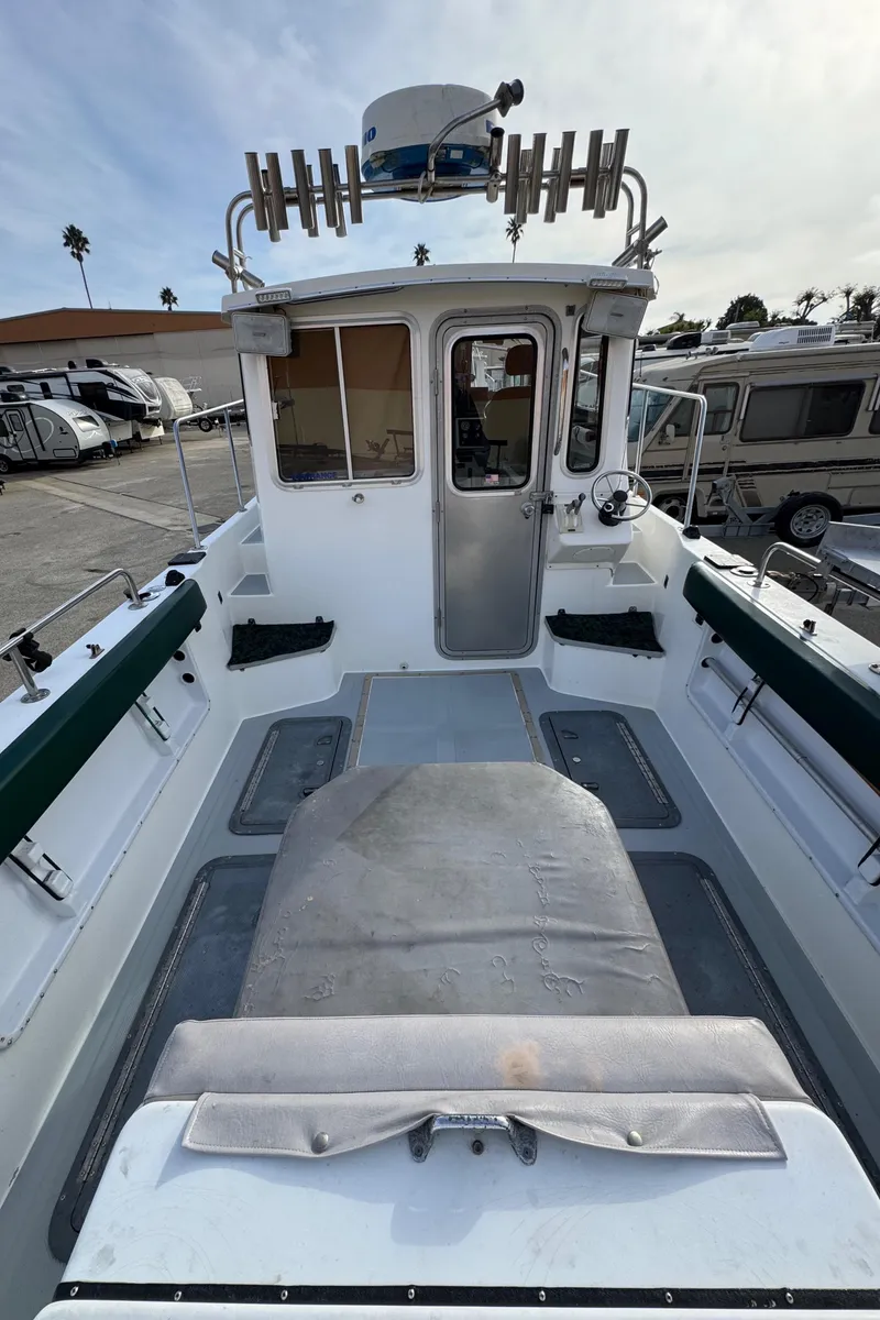Slide: The Image of 1999 Osprey 26 Legend boat interior with seating and steering wheel. - 16