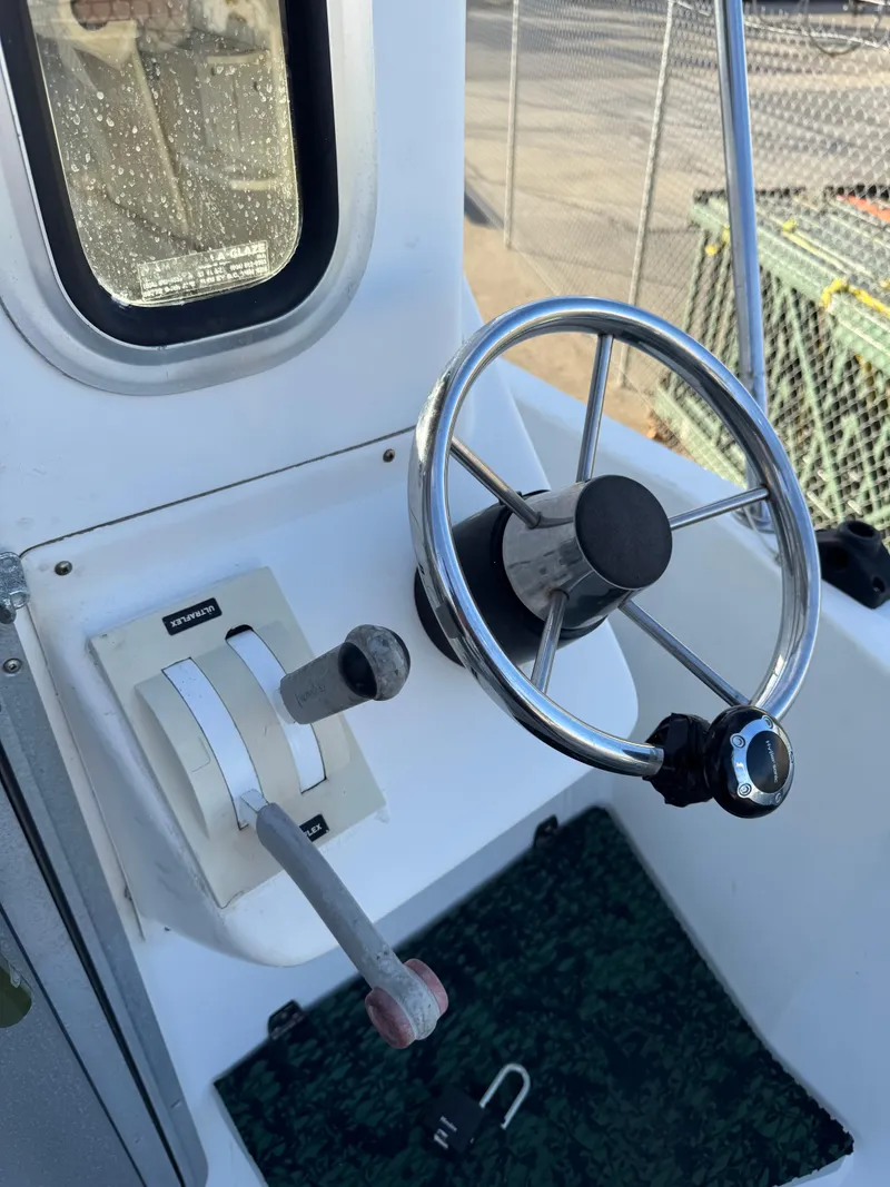 Slide: The Image of 1999 Osprey 26 Legend boat steering wheel and controls in cockpit. - 4