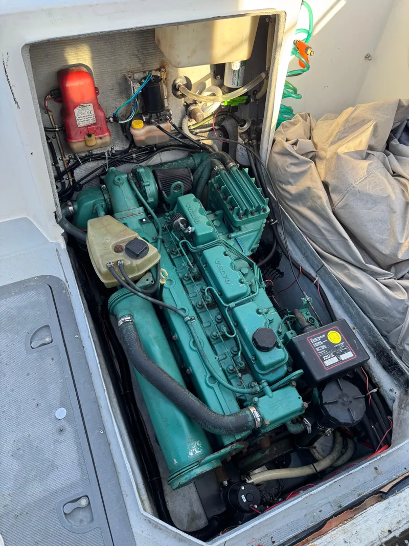 Slide: The Image of 1999 Osprey 26 Legend boat engine compartment with visible components and wiring. - 6