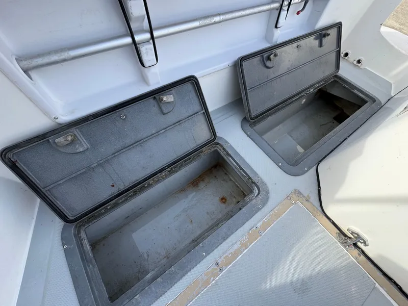 Slide: The Image of Open storage compartments on a 1999 Osprey 26 Legend boat deck. - 8