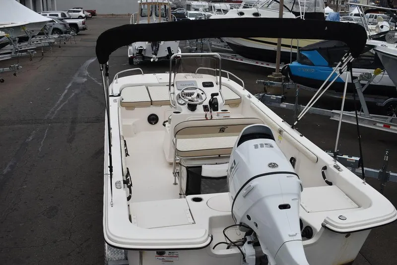 Slide: The Image of 2022 Carolina Skiff 19 LS boat with outboard motor in a marina setting. - 11