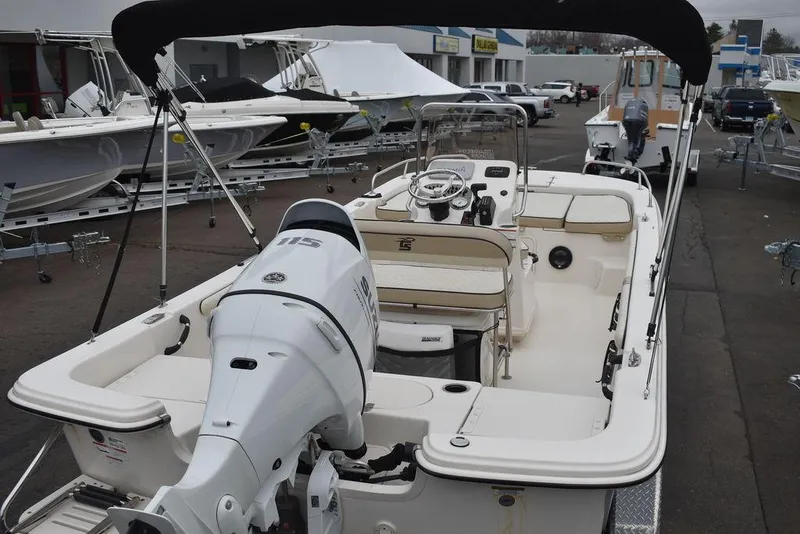 Slide: The Image of 2022 Carolina Skiff 19 LS boat with outboard motor and canopy in a dealership lot. - 12