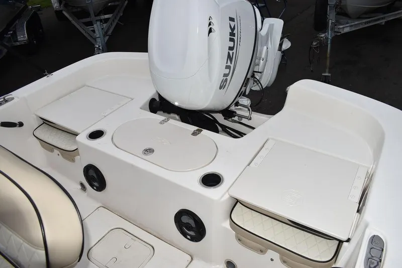 Slide: The Image of 2022 Carolina Skiff 19 LS boat with Suzuki outboard motor, featuring spacious seating and storage. - 15