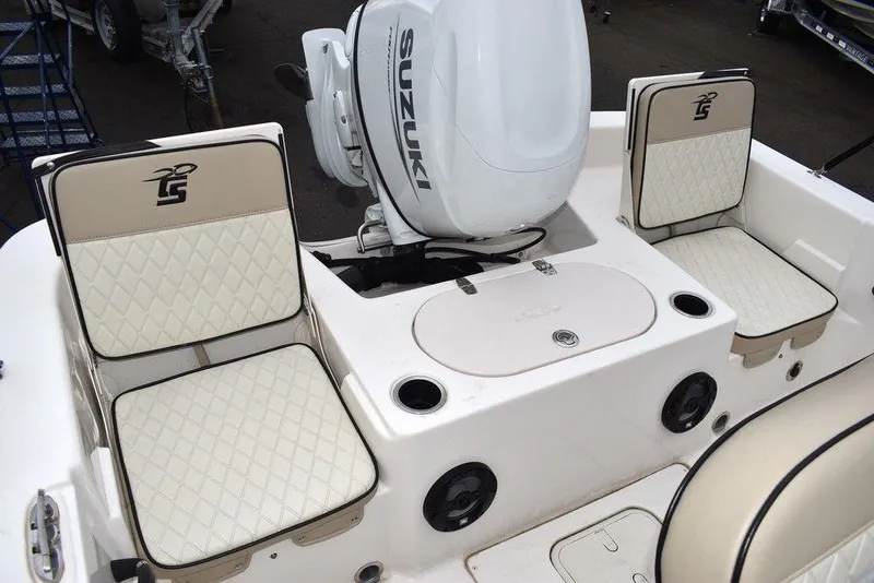 Slide: The Image of 2022 Carolina Skiff 19 LS boat interior with Suzuki engine and cushioned seating. - 17