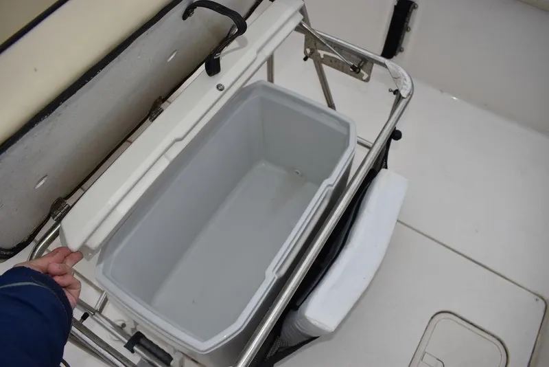 Slide: The Image of 2022 Carolina Skiff 19 LS boat cooler storage compartment. - 23