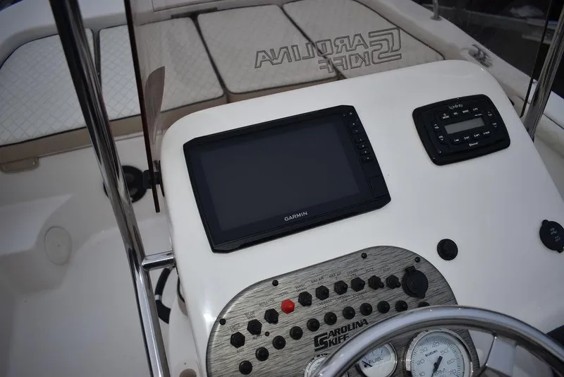 Slide: The Image of 2022 Carolina Skiff 19 LS dashboard with Garmin display and control panel. - 28