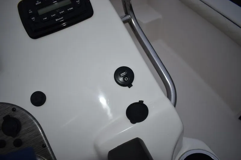 Slide: The Image of 2022 Carolina Skiff 19 LS boat dashboard with USB port and controls. - 29