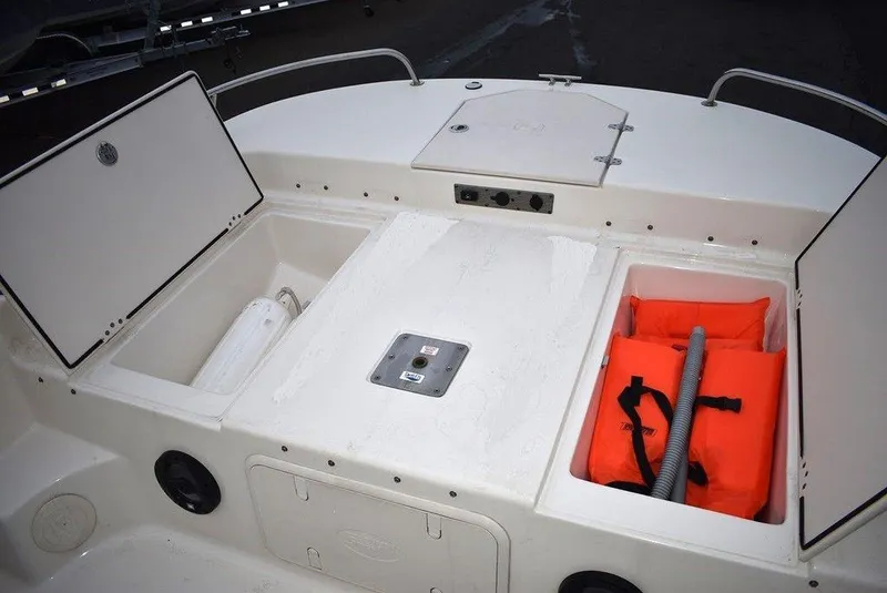 Slide: The Image of 2022 Carolina Skiff 19 LS boat storage compartments with life jackets and equipment. - 35