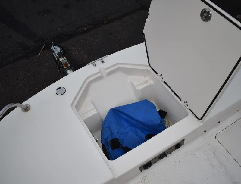 Slide: The Image of 2022 Carolina Skiff 19 LS boat storage compartment with blue bag. - 36