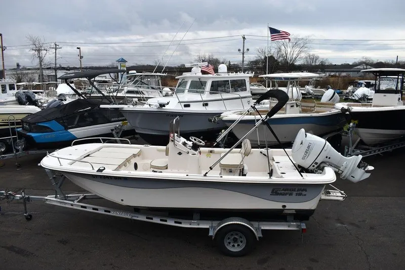 Slide: The Image of 2022 Carolina Skiff 19 LS boat on trailer in marina setting. - 5