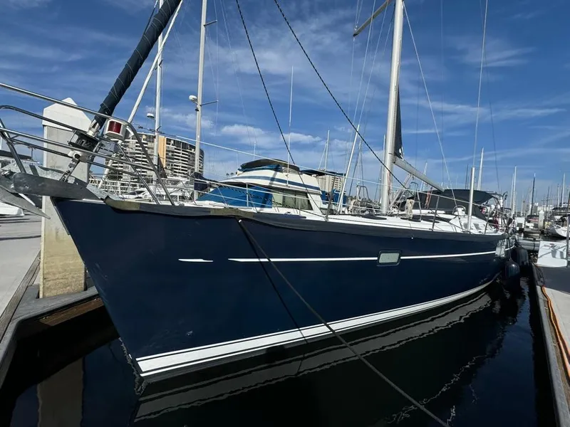 Slide: The Image of 2004 Beneteau Oceanis Clipper 473 sailboat docked at marina under clear blue sky. - 0
