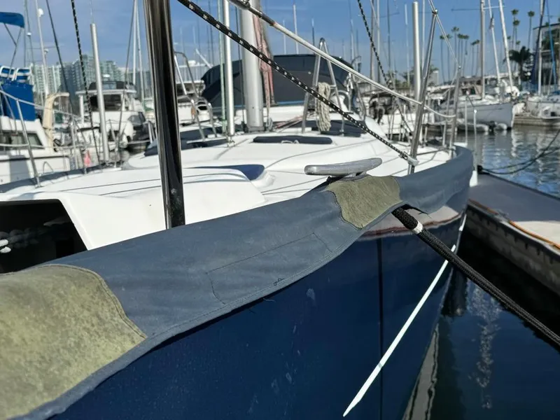 Slide: The Image of 2004 Beneteau Oceanis Clipper 473 sailboat docked in marina, close-up view. - 13