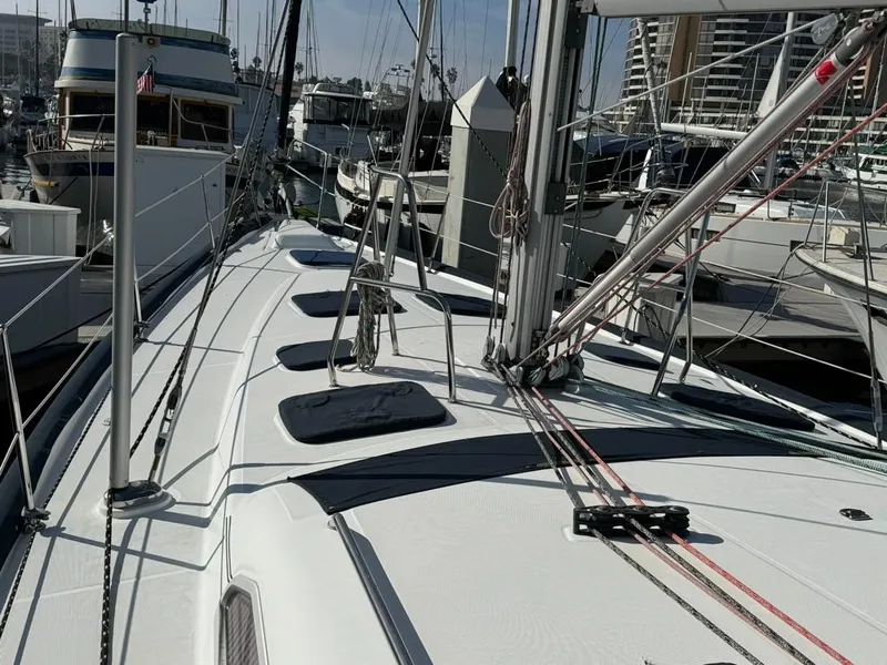 Slide: The Image of 2004 Beneteau Oceanis Clipper 473 sailboat docked in a marina, showcasing deck and rigging. - 14