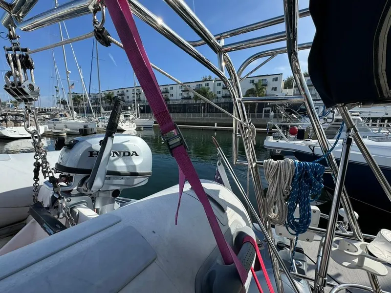 Slide: The Image of Beneteau Oceanis Clipper 473 sailboat deck with Honda outboard motor, docked in marina, 2004 model. - 19