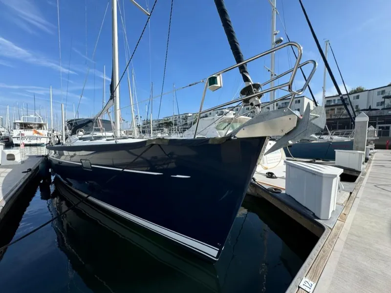 Slide: The Image of 2004 Beneteau Oceanis Clipper 473 sailboat docked in marina under clear blue sky. - 2