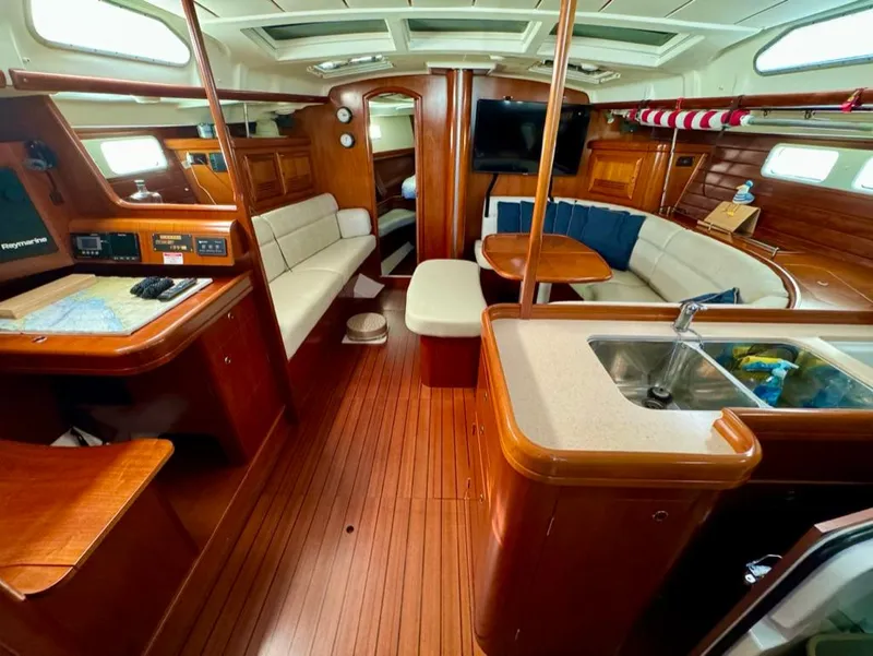 Slide: The Image of Luxurious interior of 2004 Beneteau Oceanis Clipper 473 sailboat with wood finish and seating. - 20