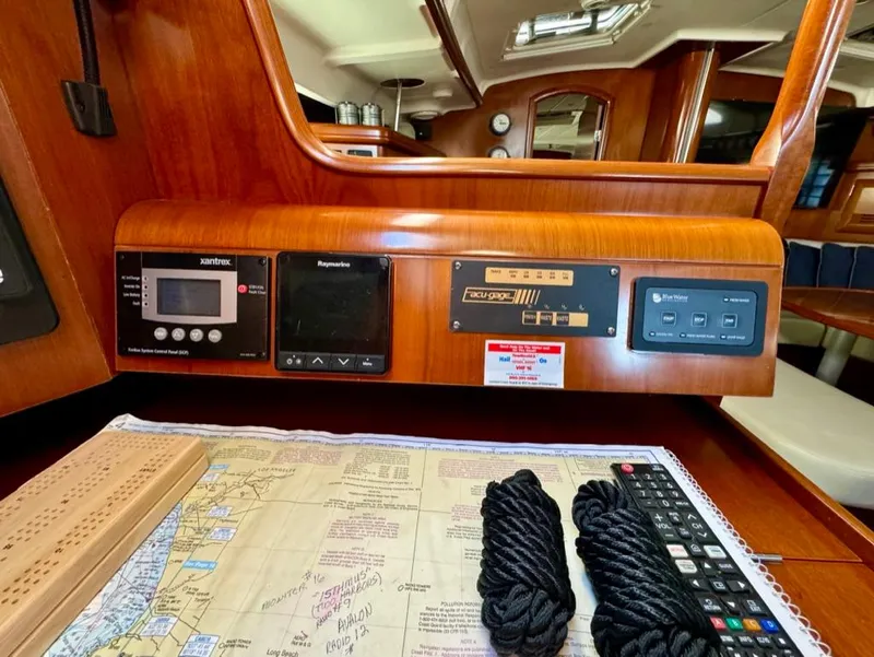 Slide: The Image of Navigation station of 2004 Beneteau Oceanis Clipper 473 with nautical chart and equipment. - 22