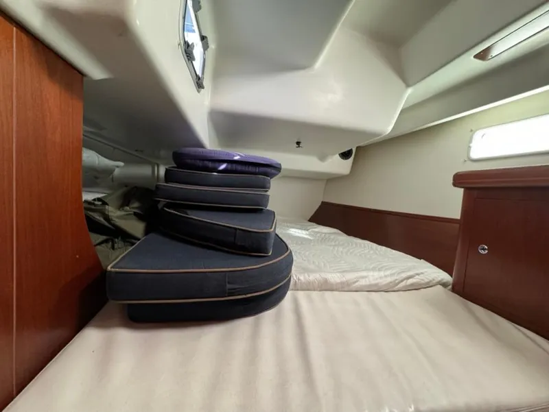 Slide: The Image of Interior cabin of 2004 Beneteau Oceanis Clipper 473 with stacked cushions. - 28