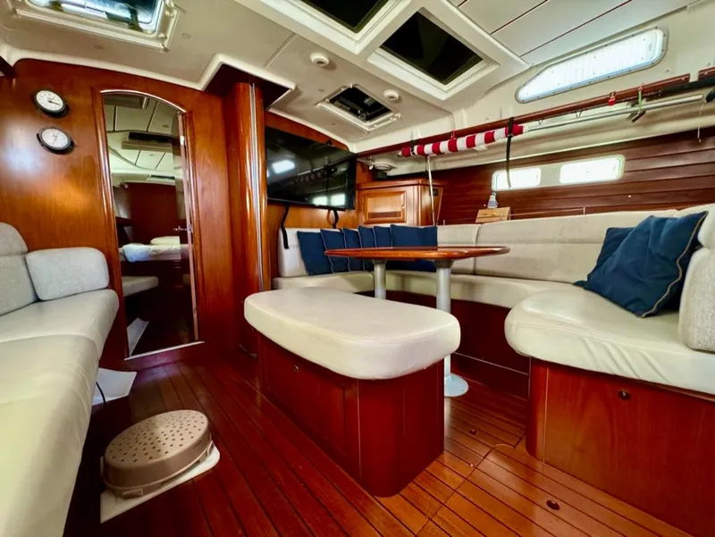 Slide: The Image of Interior of 2004 Beneteau Oceanis Clipper 473 yacht with wood finish and cozy seating. - 36