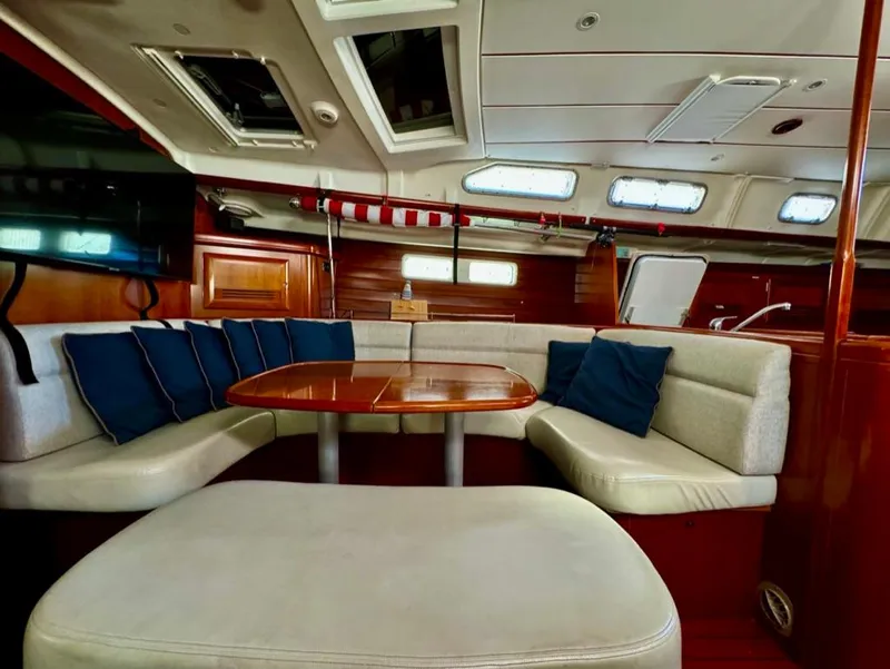 Slide: The Image of Interior of 2004 Beneteau Oceanis Clipper 473 yacht with cozy seating and wooden table. - 37