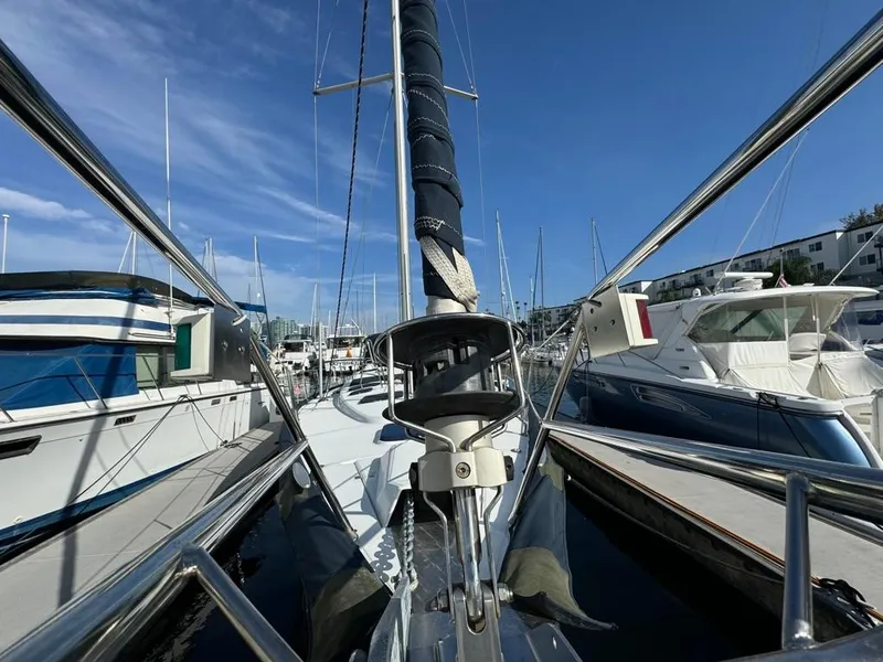 Slide: The Image of 2004 Beneteau Oceanis Clipper 473 sailboat docked in marina, surrounded by other boats. - 4
