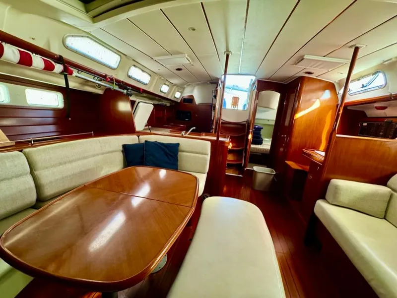 Slide: The Image of Interior of 2004 Beneteau Oceanis Clipper 473 yacht, featuring elegant wood finishes and comfortable seating. - 45