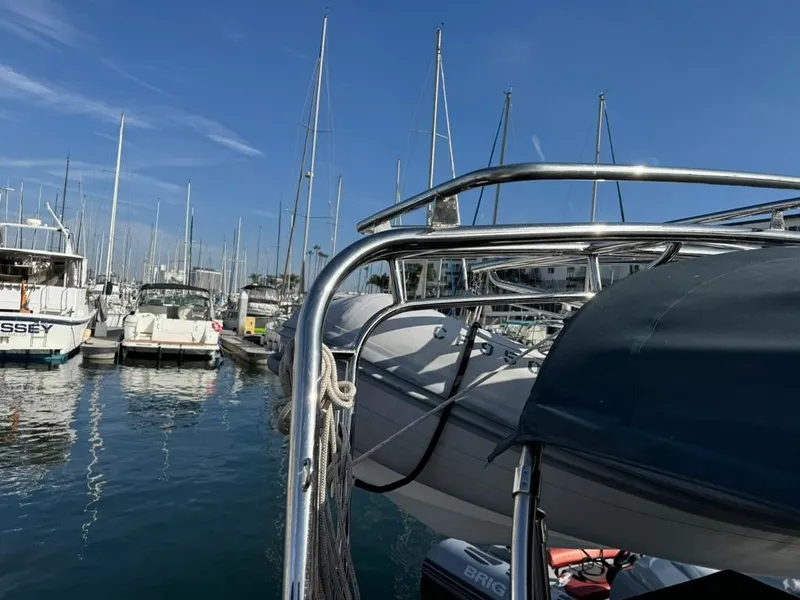 Slide: The Image of Beneteau Oceanis Clipper 473, 2004, docked in a marina with clear blue skies. - 47