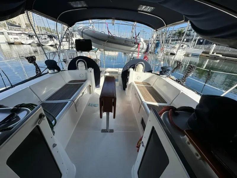 Slide: The Image of 2004 Beneteau Oceanis Clipper 473 yacht cockpit with seating, docked at marina. - 5