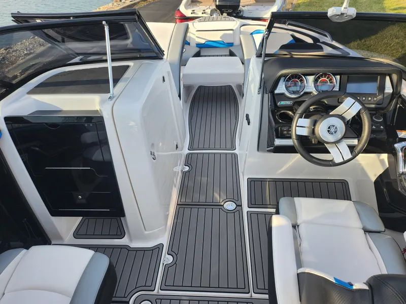 Slide: The Image of 2016 Yamaha Boats 242X E-Series interior with sleek dashboard and modern seating. - 11
