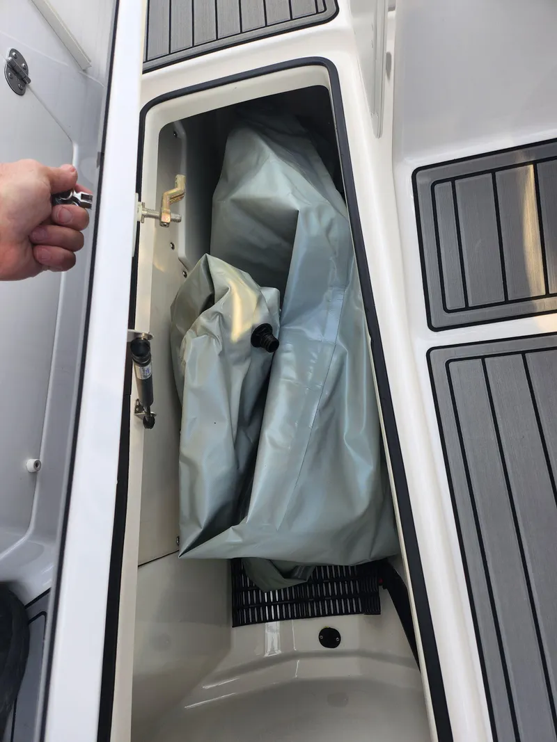 Slide: The Image of Storage compartment of 2016 Yamaha Boats 242X E-Series with gray cover inside. - 12