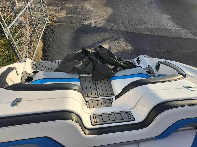 Slide: The Image of 2016 Yamaha Boats 242X E-Series, rear seating area with blue and black accents. - 20