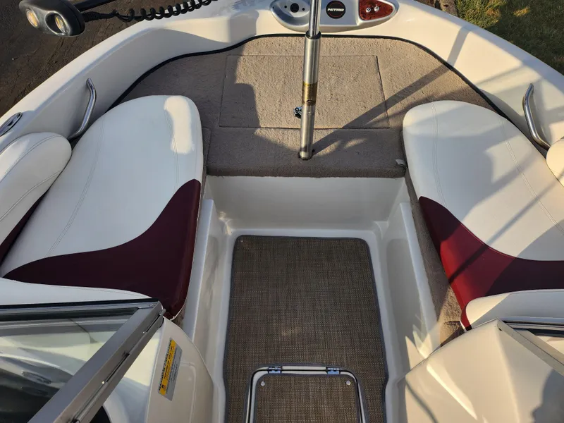 Slide: The Image of 2013 Nitro 290 Sport boat interior with white and maroon seating. - 17