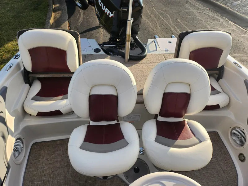 Slide: The Image of 2013 Nitro 290 Sport boat interior with four cushioned seats and Mercury engine. - 23