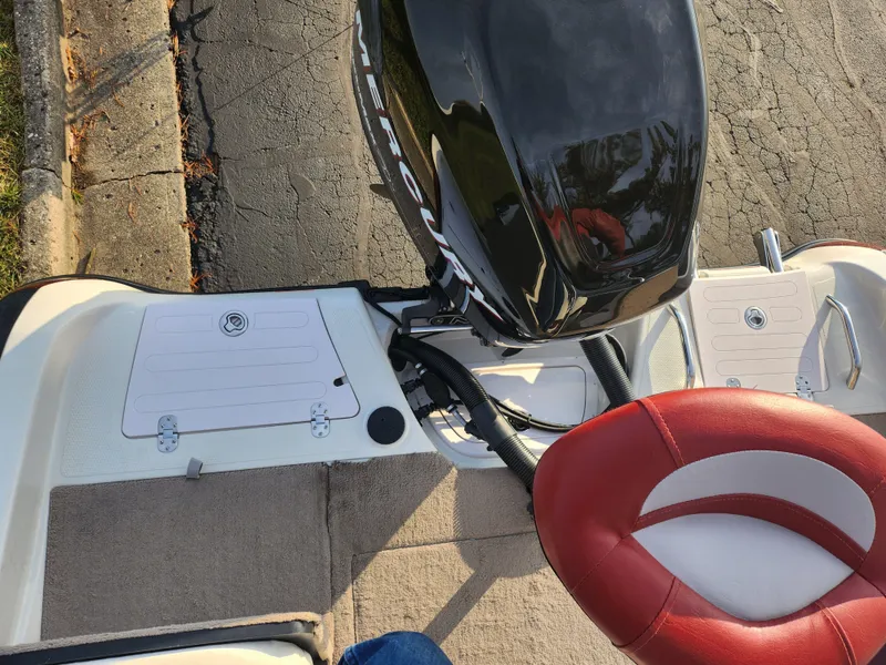 Slide: The Image of 2013 Nitro 290 Sport boat with red and white seating and Mercury outboard motor. - 24